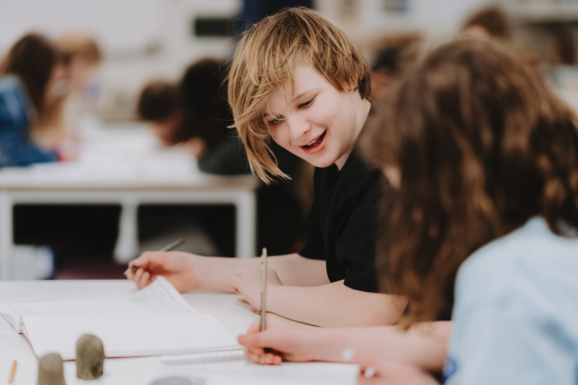 Candlebark student smiling and working